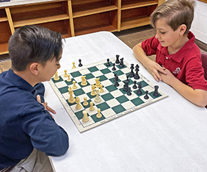 Boys go head to head in a game of Chess.