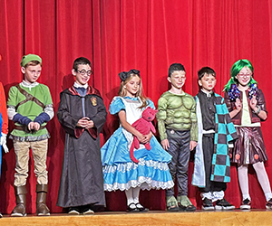 Halloween costumed students line up with their class.