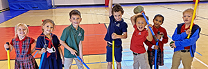 Young students with their hockey-ball sticks during Physical Education.